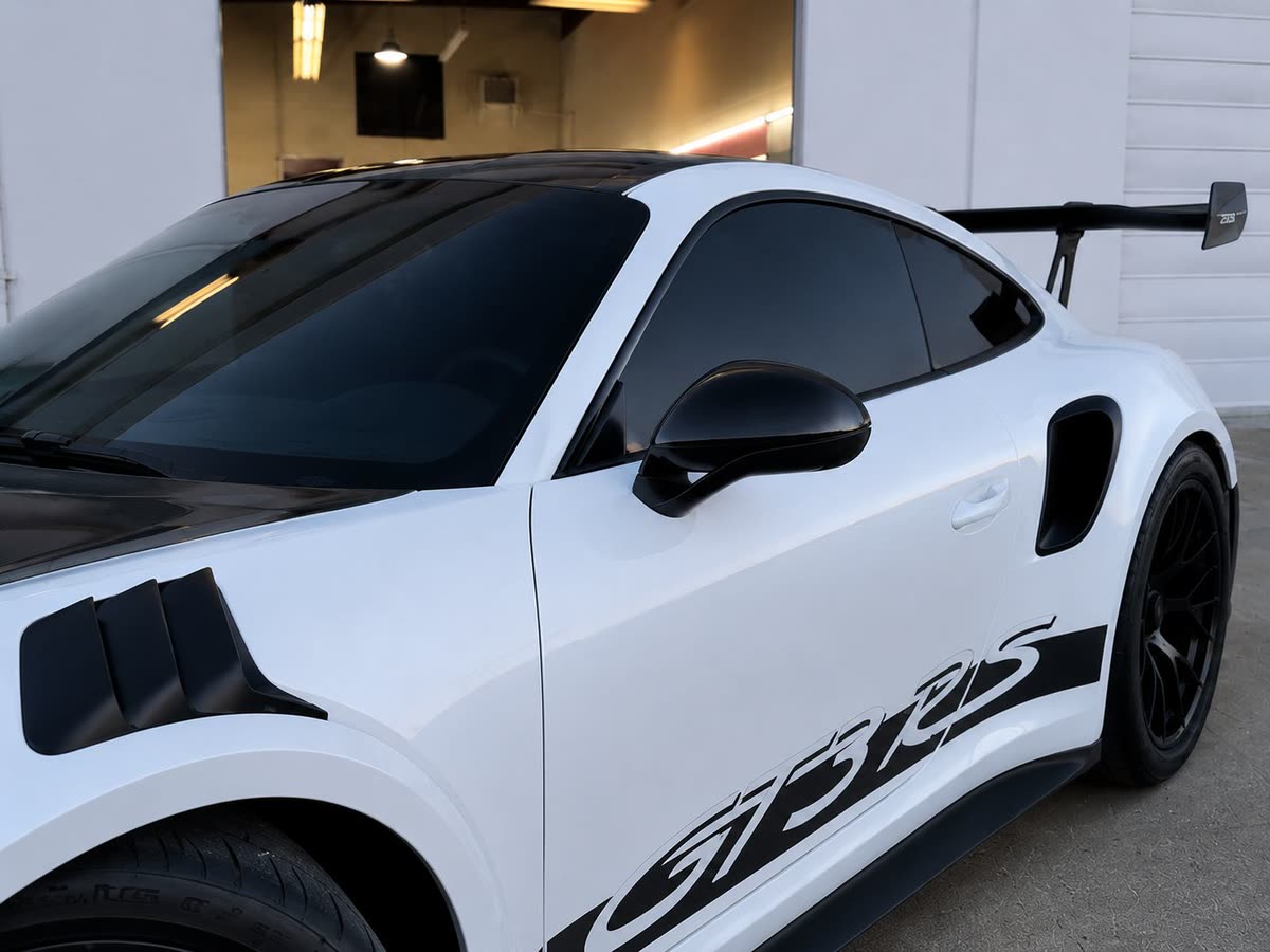 White Porsche 911 GT3 RS with blacked-out tinted windows